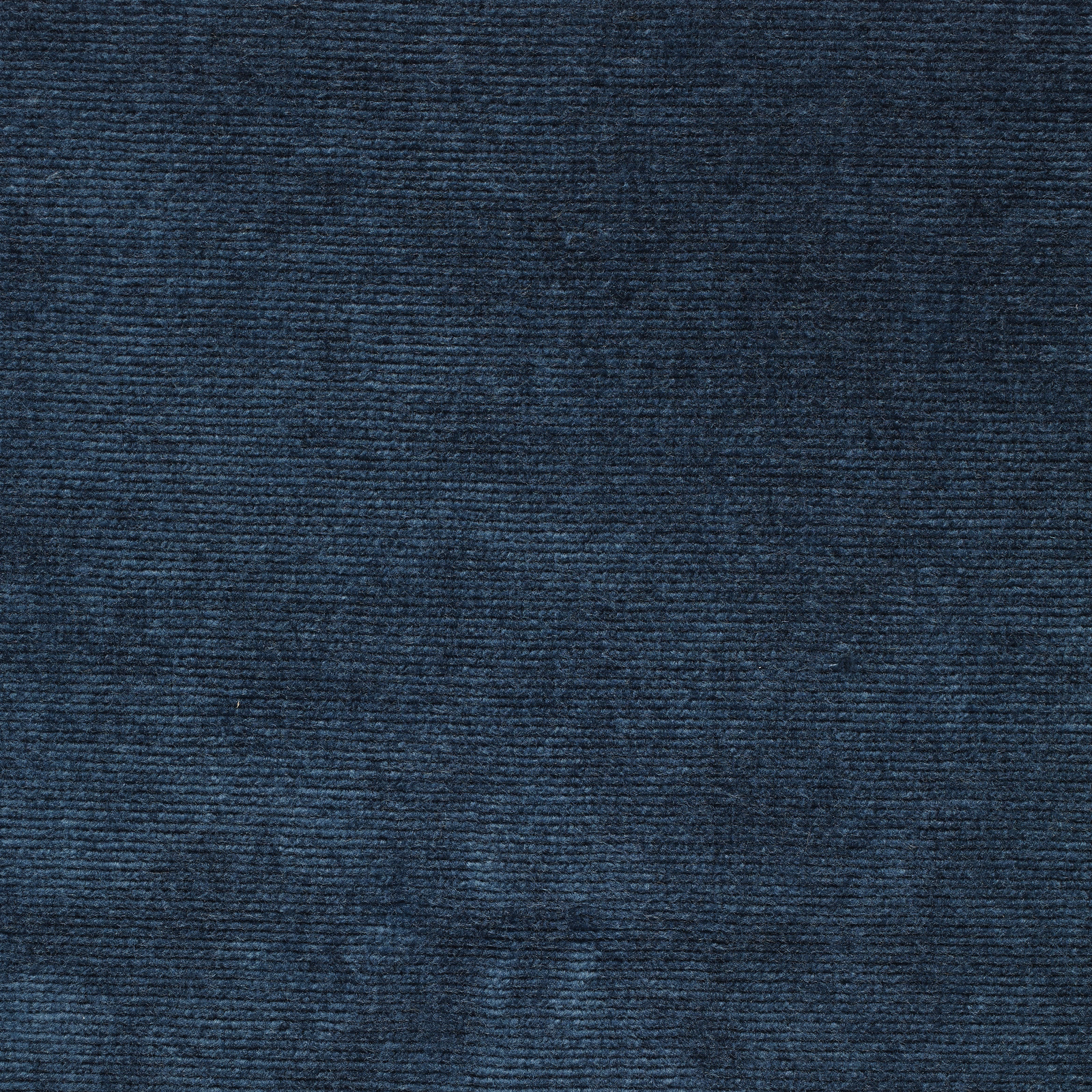 Close-up of deep marine teal velvet with a dense, ribbed pile texture
