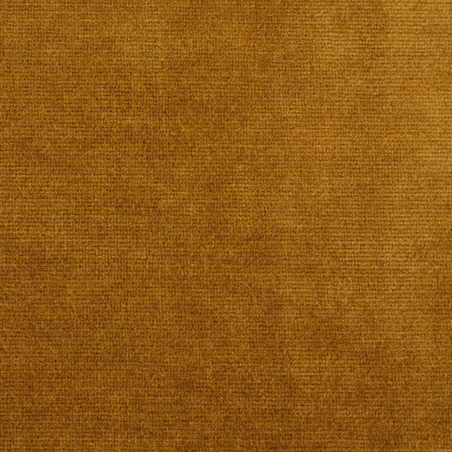 Close-up of warm old gold velvet with a subtle mottled pile texture