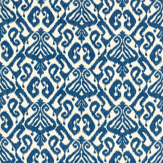 Blue and cream geometric ikat-style fabric swatch with repeating motifs