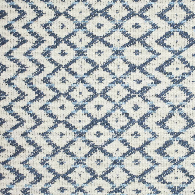 Close-up of indigo and ivory woven diamond lattice fabric with textured surface