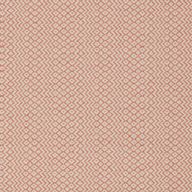 Close-up of a warm sandstone geometric weave with terracotta zigzags and speckled accents