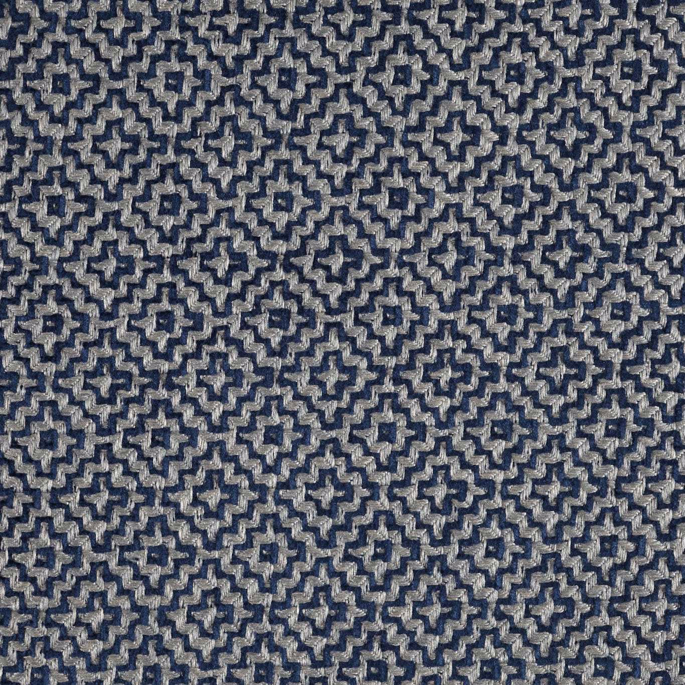 Close-up of indigo blue geometric woven fabric with small cream accents