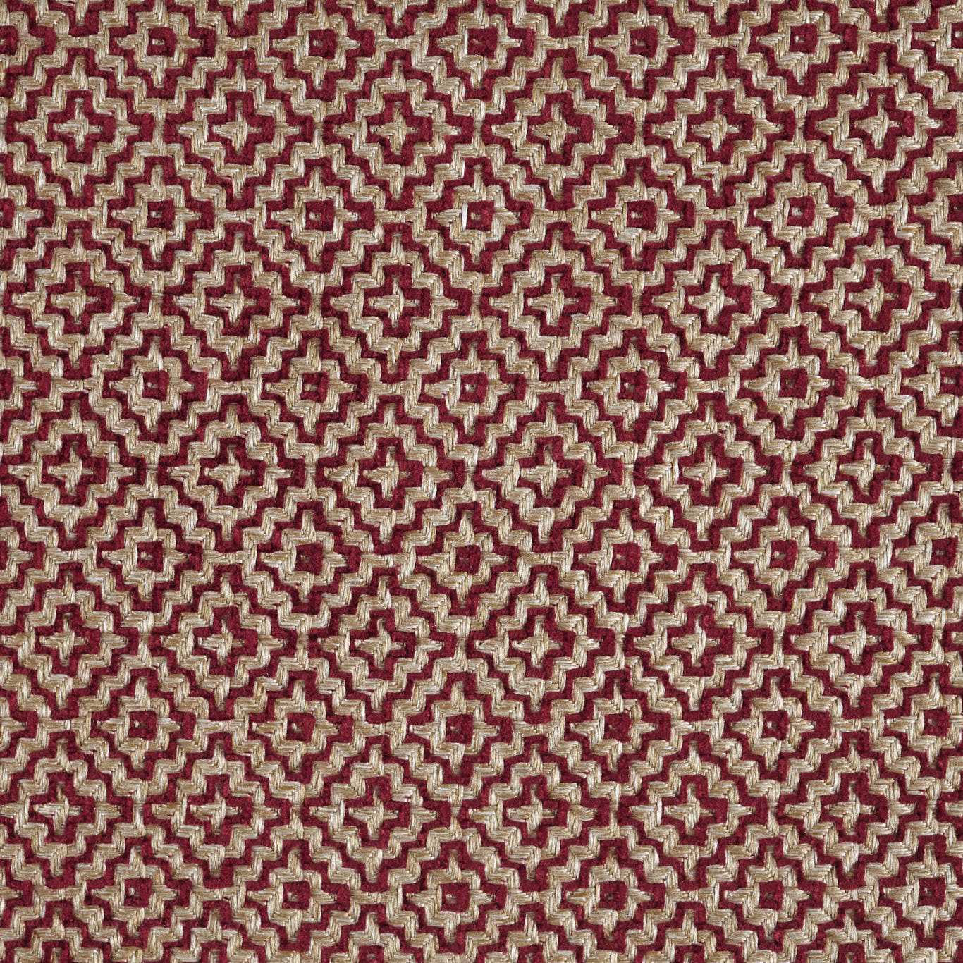 Close-up of a russet red and stone geometric woven fabric with small repeating motif