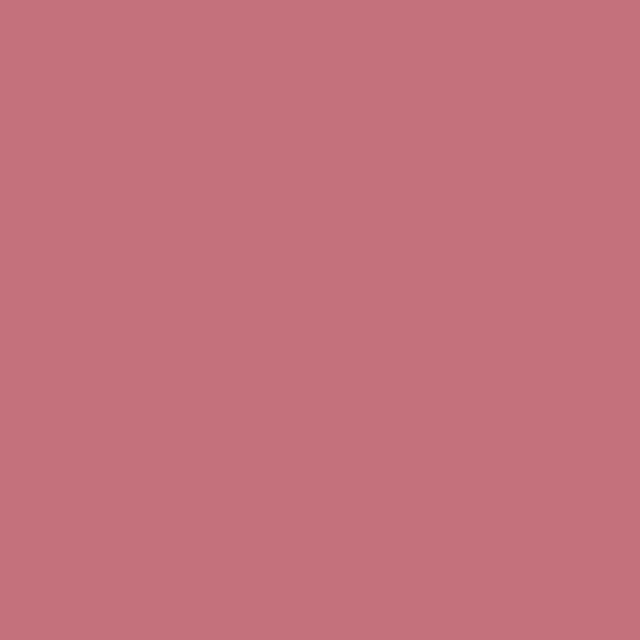 a flat tile of warm pinkish red paint