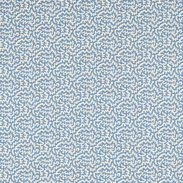 Close-up of pale ground fabric with dense indigo small-scale dotted pattern