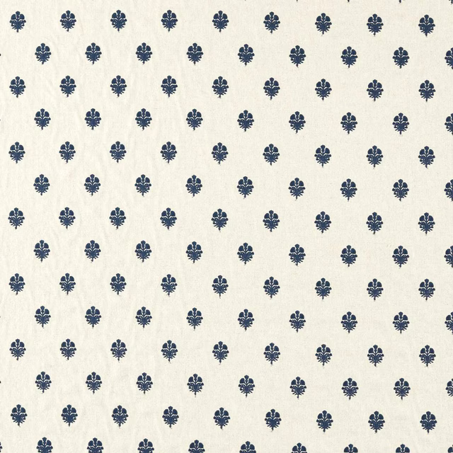 Cream fabric swatch with small indigo repeating motifs