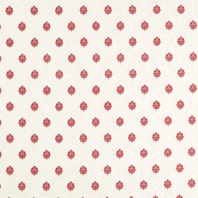 Small madder-red ikat motifs on an ivory woven fabric swatch