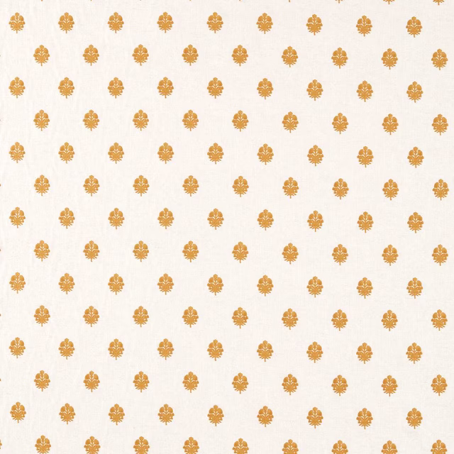 Pale ground fabric with small turmeric-gold repeating motifs in a neat grid