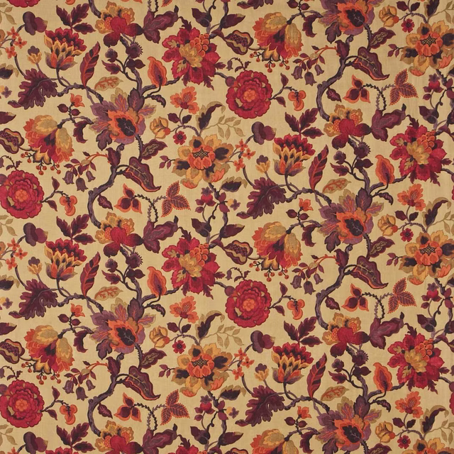 Dense floral fabric with warm gold ground, aubergine stems and coral blooms