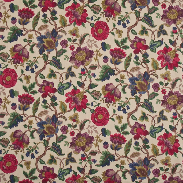 Ivory chintz fabric with jewel-toned floral branches and dense painterly foliage