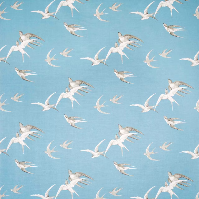 Blue fabric swatch with flying swallow pattern in white and grey