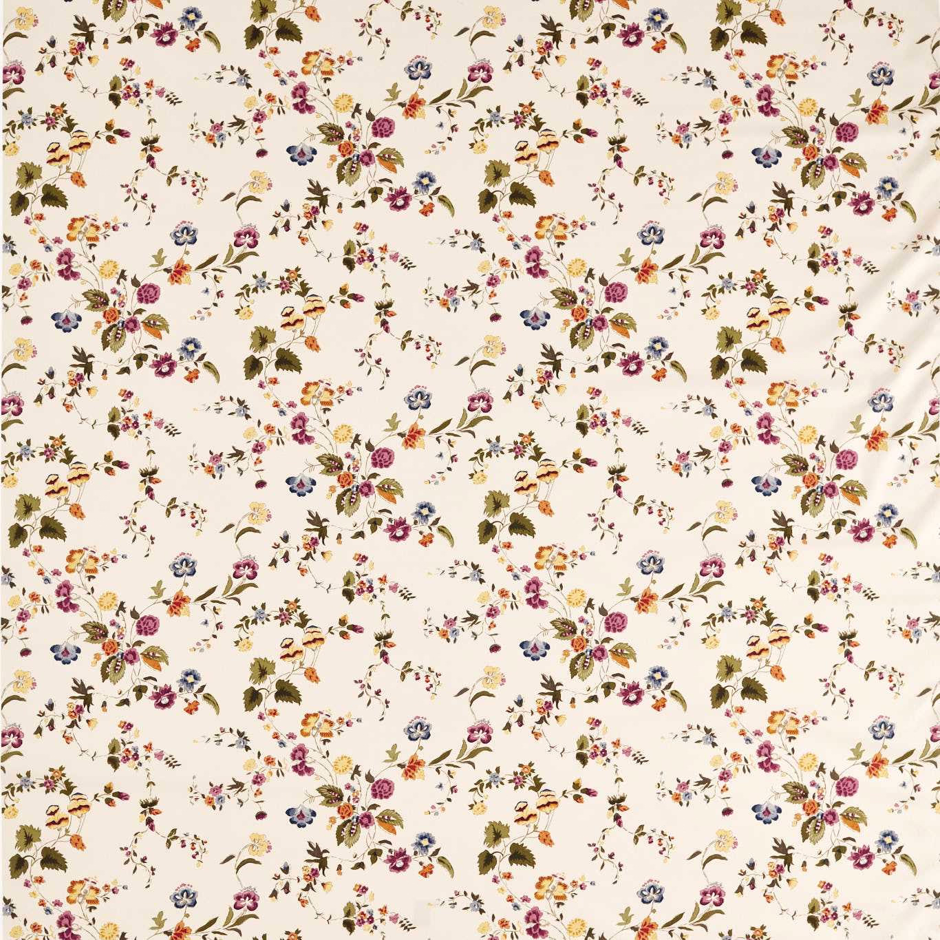 Cream floral printed fabric with scattered damson, blue and ochre sprigs