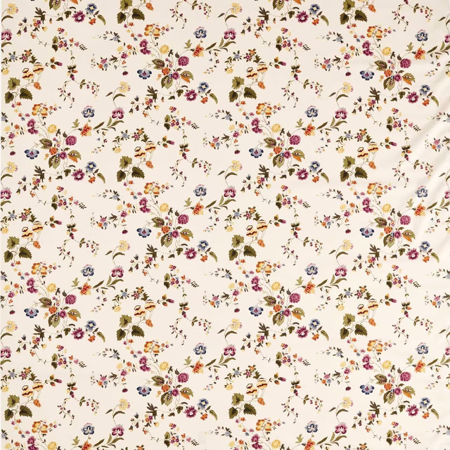 Cream floral printed fabric with scattered damson, blue and ochre sprigs