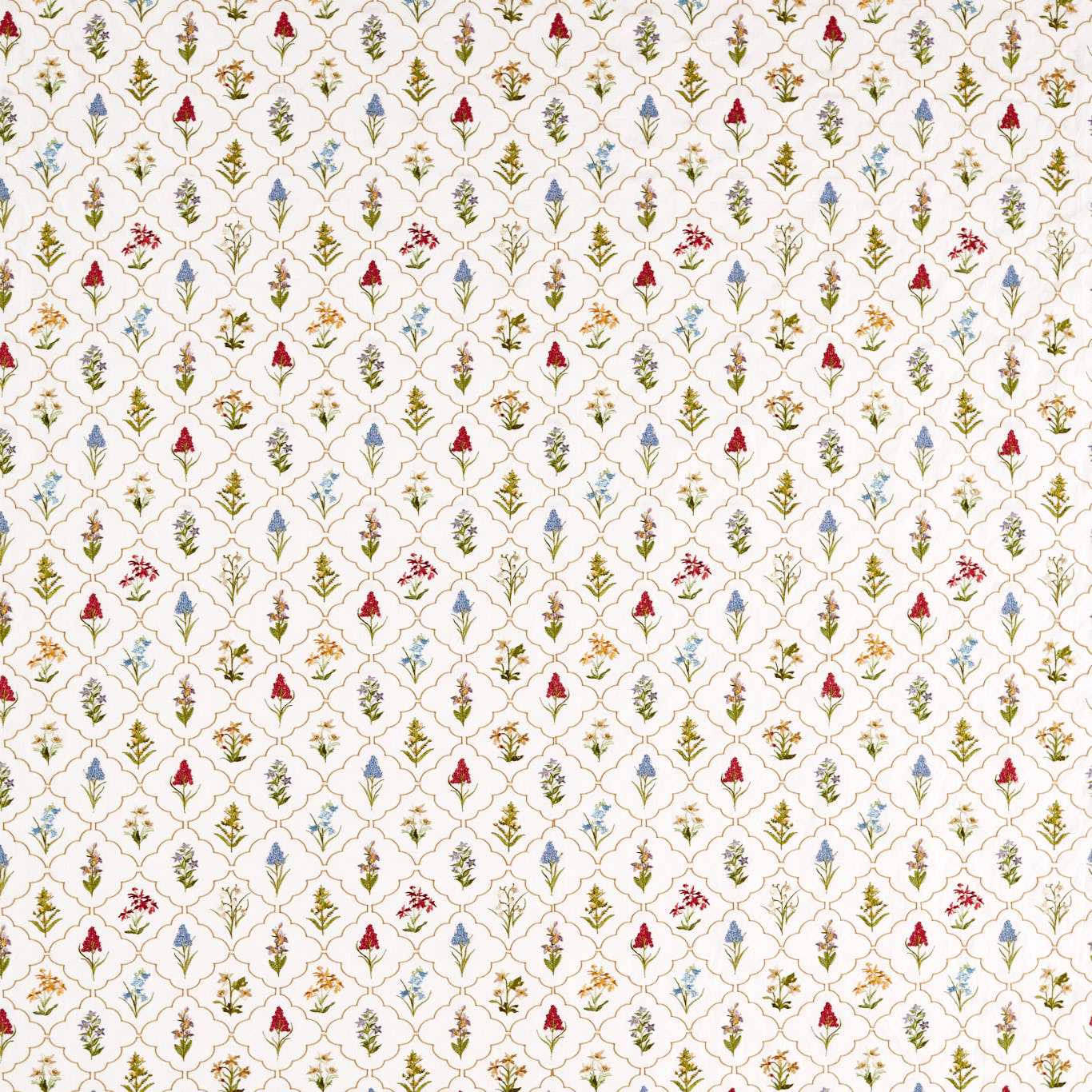 Cream embroidered fabric with tiny red, blue and green floral sprigs