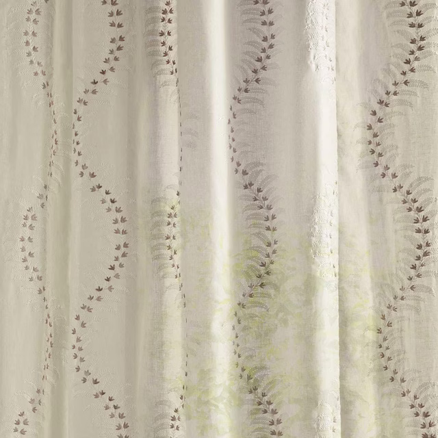 Cream sheer fabric with trailing leaf-like botanical stripes and soft woven texture