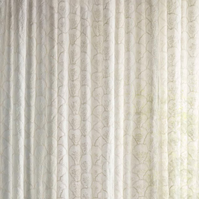 Sheer ivory cream fabric with faint botanical pattern and soft filtered light