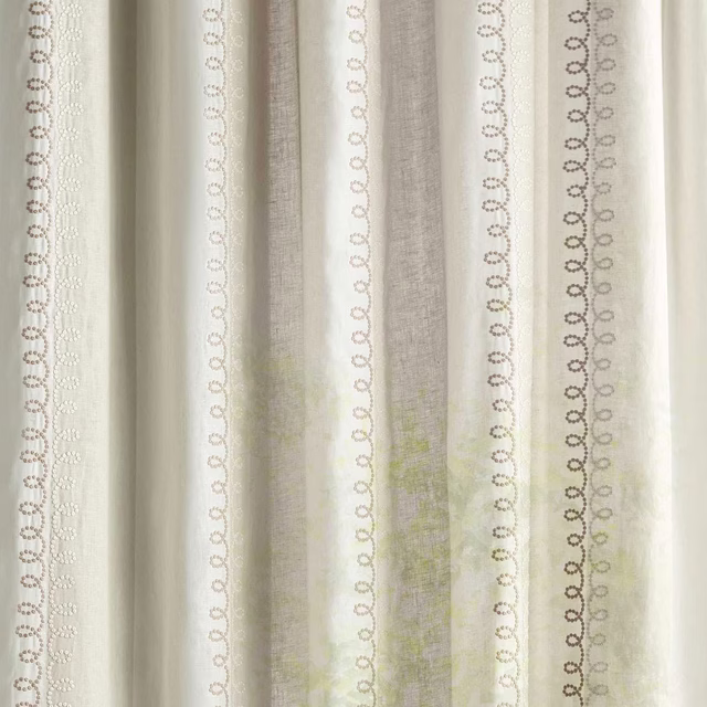 Cream sheer fabric with vertical looped stripe motifs in soft sand tones