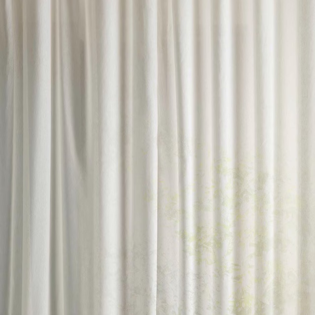 Pale ivory sheer fabric with faint seaspray floral pattern and soft vertical folds