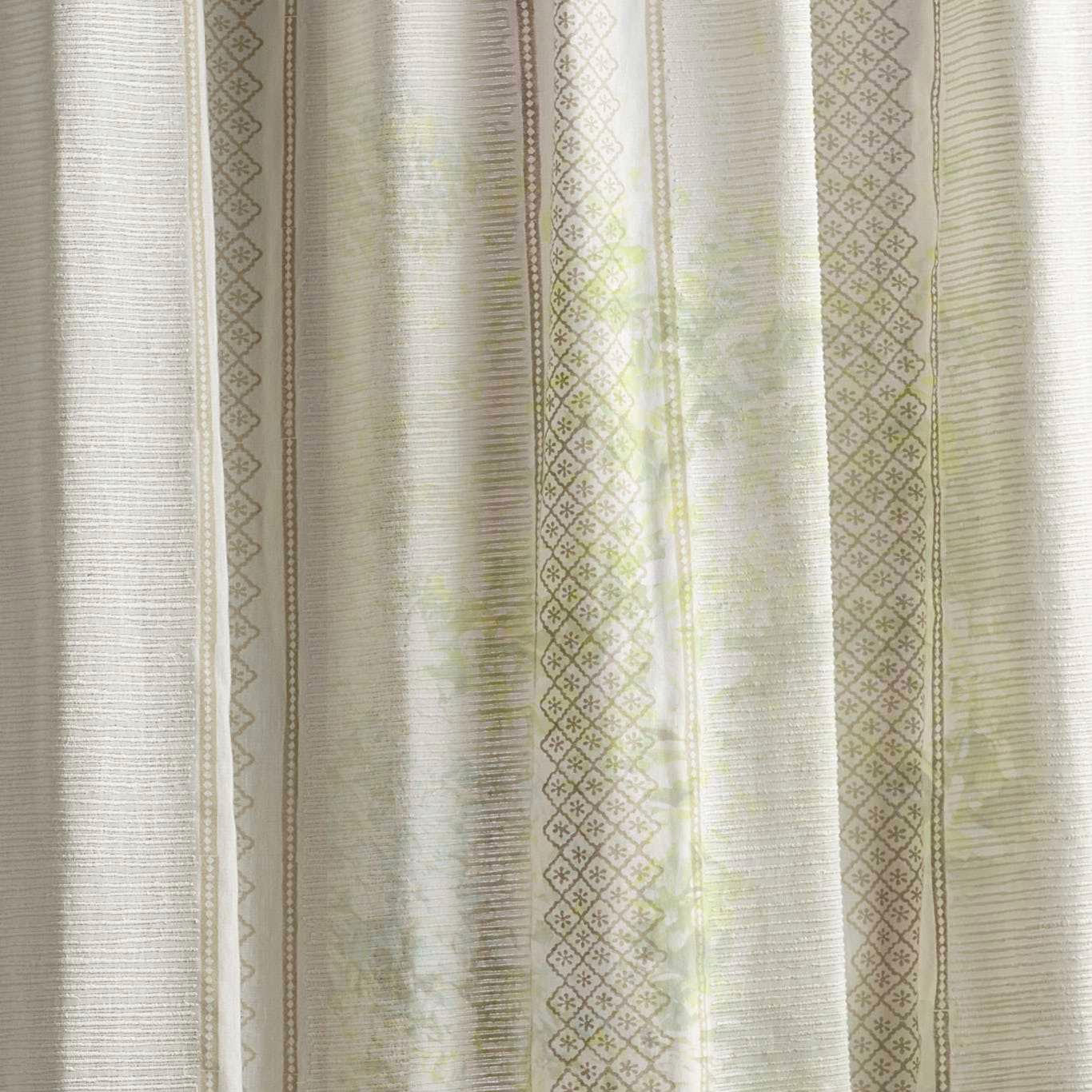 Sheer striped fabric swatch in soft seaspray green and sand with lattice detailing