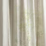 Sheer striped fabric swatch in soft seaspray green and sand with lattice detailing
