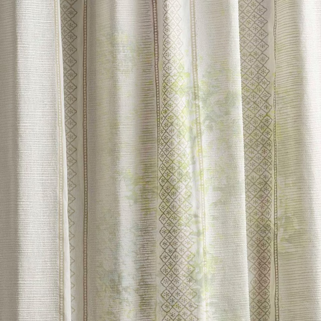 Sheer striped fabric swatch in soft seaspray green and sand with lattice detailing