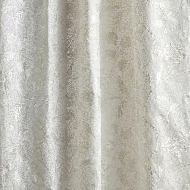 Sheer floral fabric in seaspray white with soft woven leaves and blooms