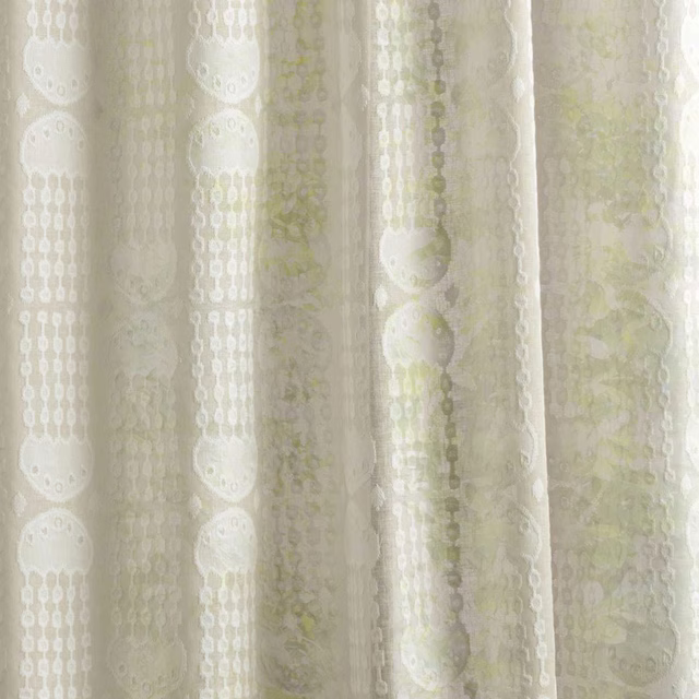 Cream sheer fabric with vertical oval motifs and pale green accents