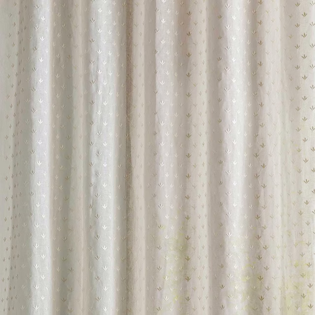 Cream sheer curtain fabric with tiny seaspray leaf motif and soft vertical folds