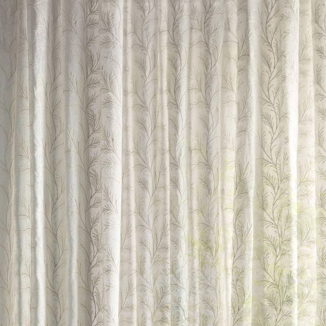 Pale cream sheer fabric with delicate fern motif and soft seafoam tint