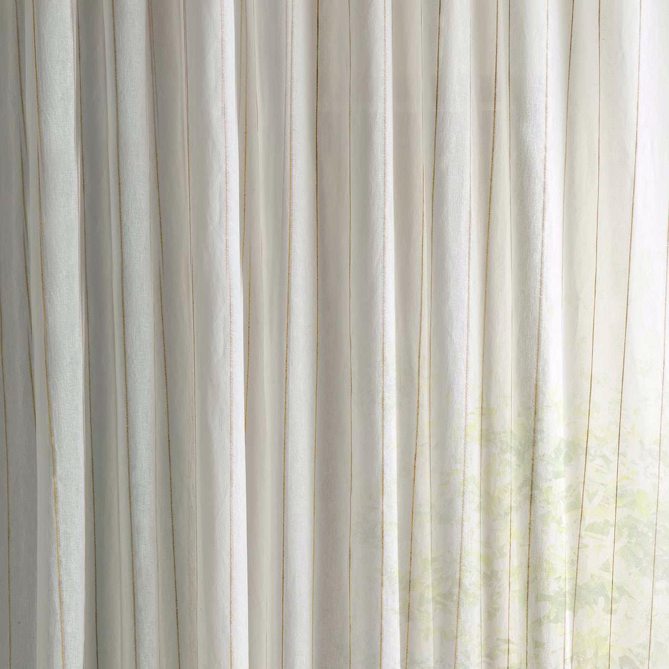 Sheer cream fabric with faint pale mimosa tint and vertical folds