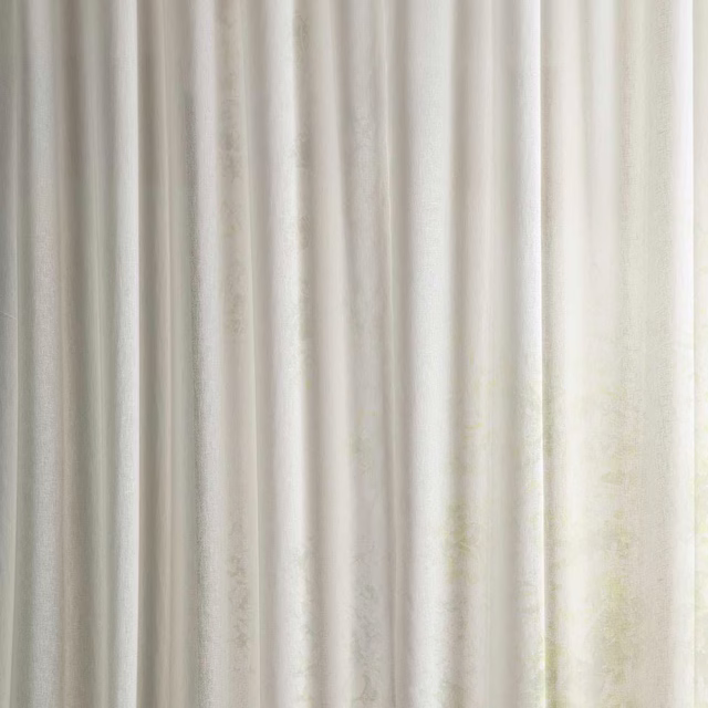 Pale seaspray white sheer fabric with soft vertical texture and gentle folds