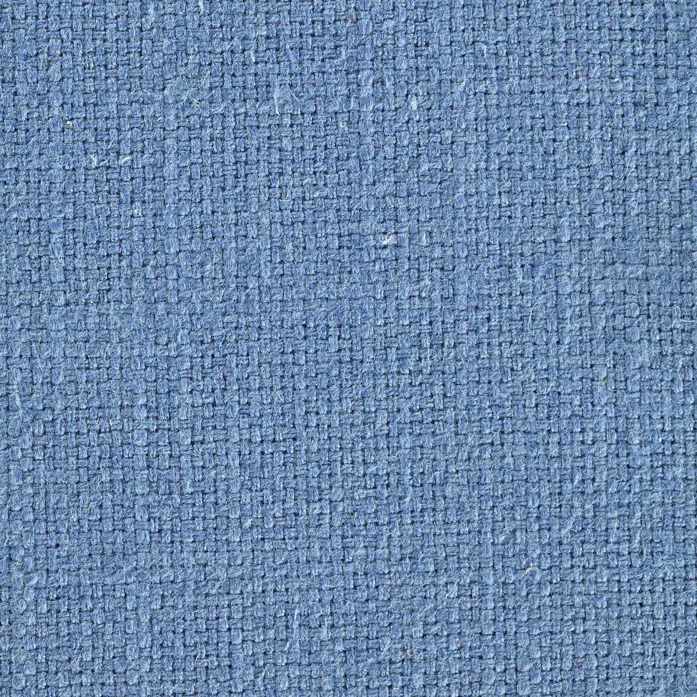 Close-up of a soft cornflower blue woven fabric with a textured nubby surface