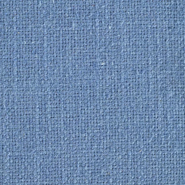 Close-up of a soft cornflower blue woven fabric with a textured nubby surface