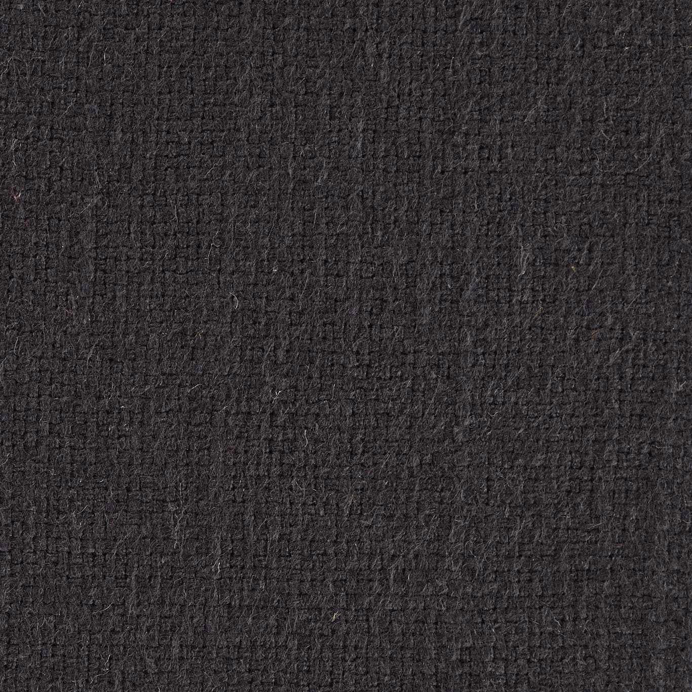 Close-up of deep charcoal black textured woven fabric with a dense plain weave