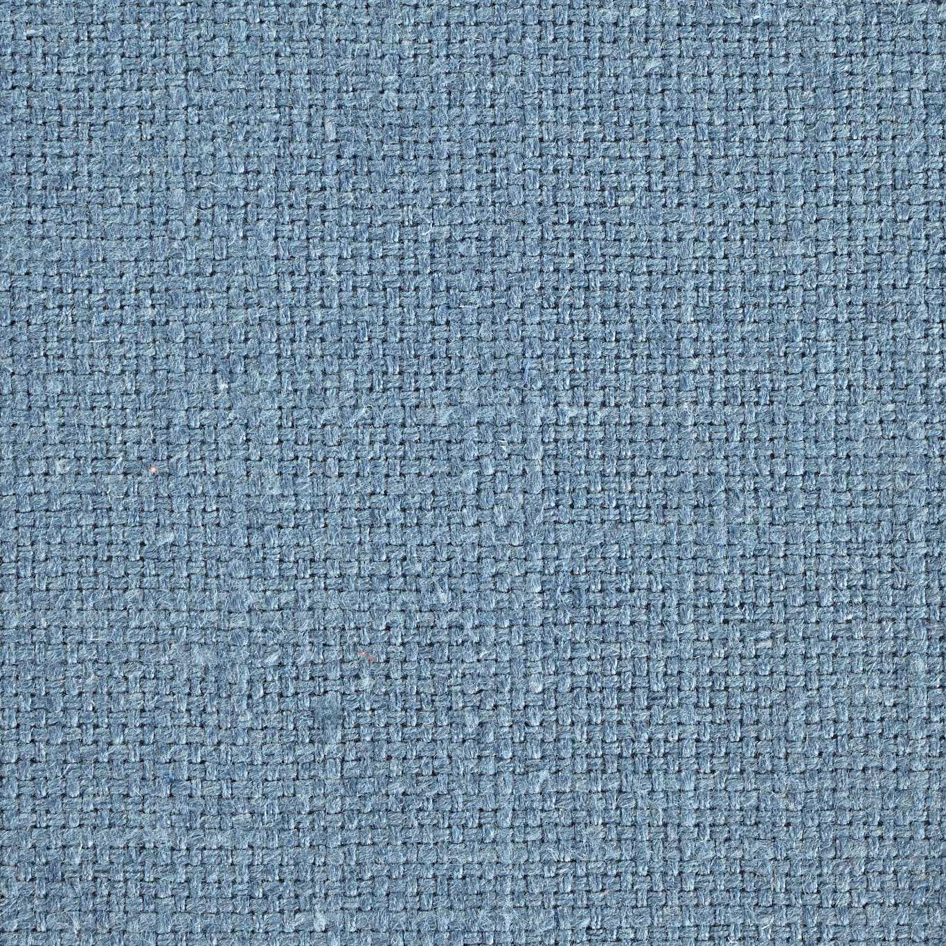 Close-up of a textured powder-blue woven fabric with a fine nubby basket weave.