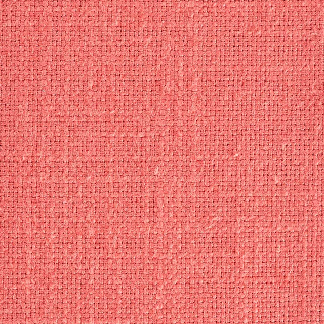 Coral pink woven fabric swatch with a dense textured basket weave