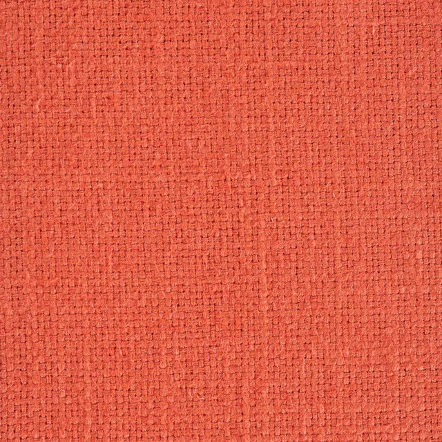 Close-up of warm peach coral woven fabric with a nubby textured plain weave
