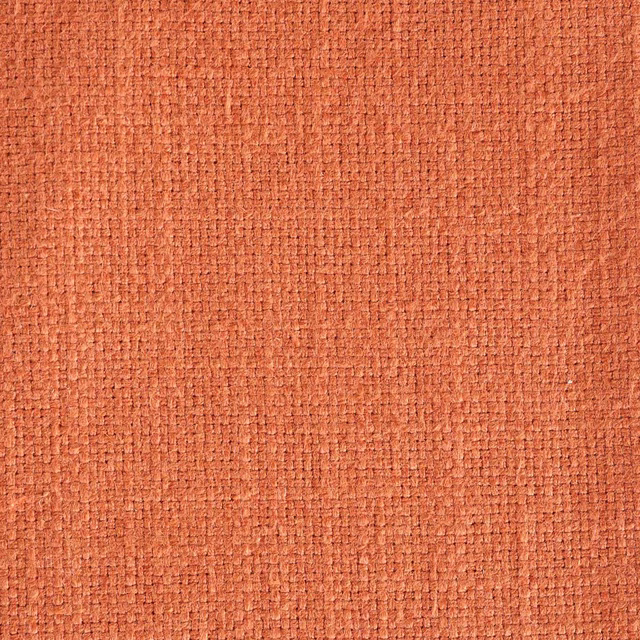 Close-up of warm berry terracotta woven fabric with a textured plain surface