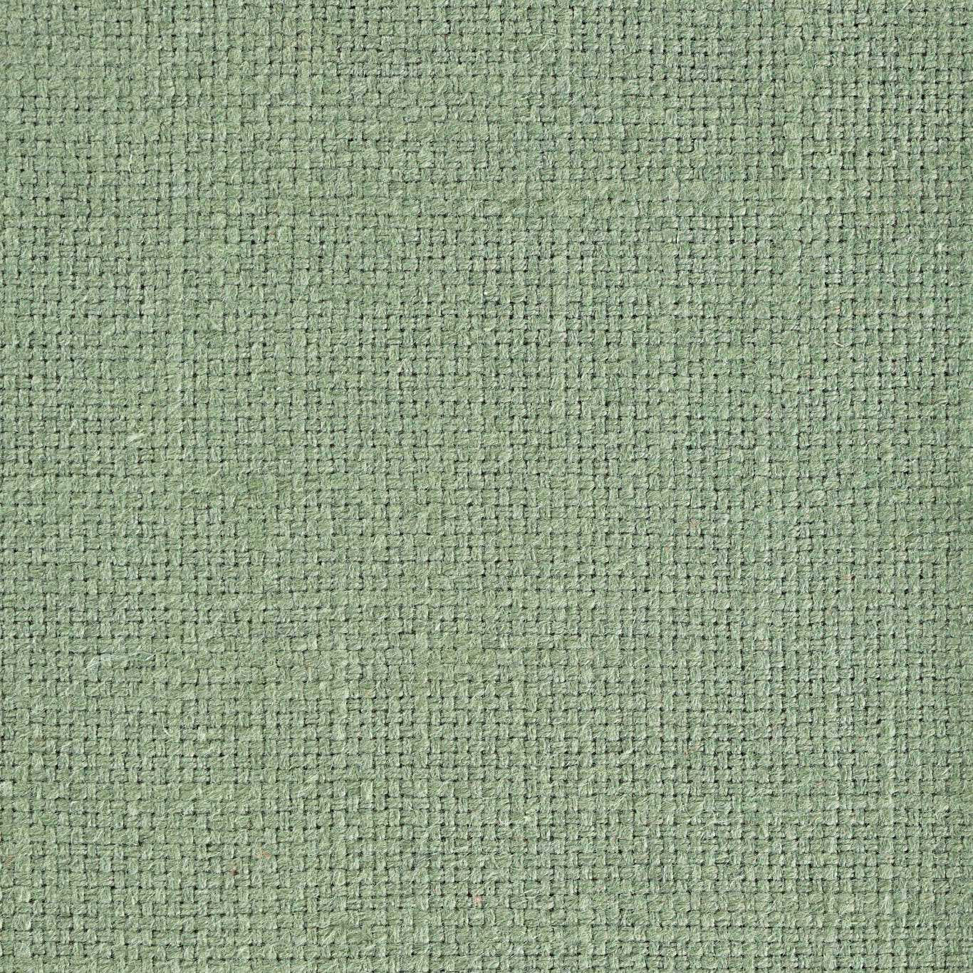 Close-up of a soft sage green textured woven fabric