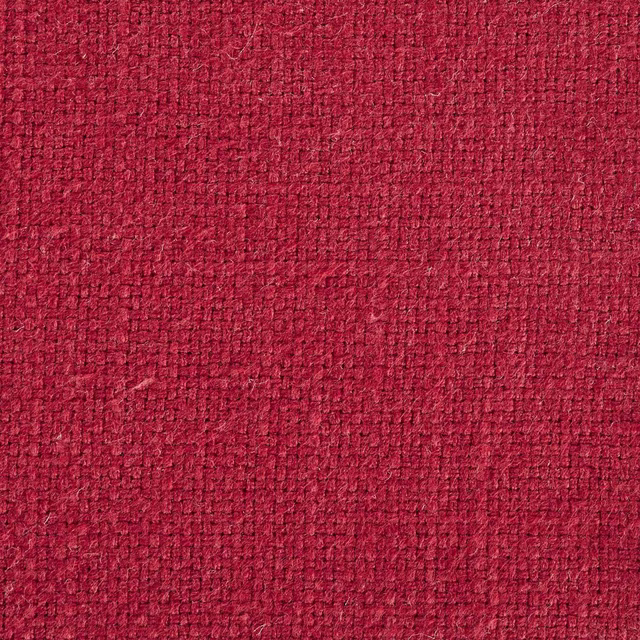 Close-up of a deep wine red woven fabric with a compact textured surface