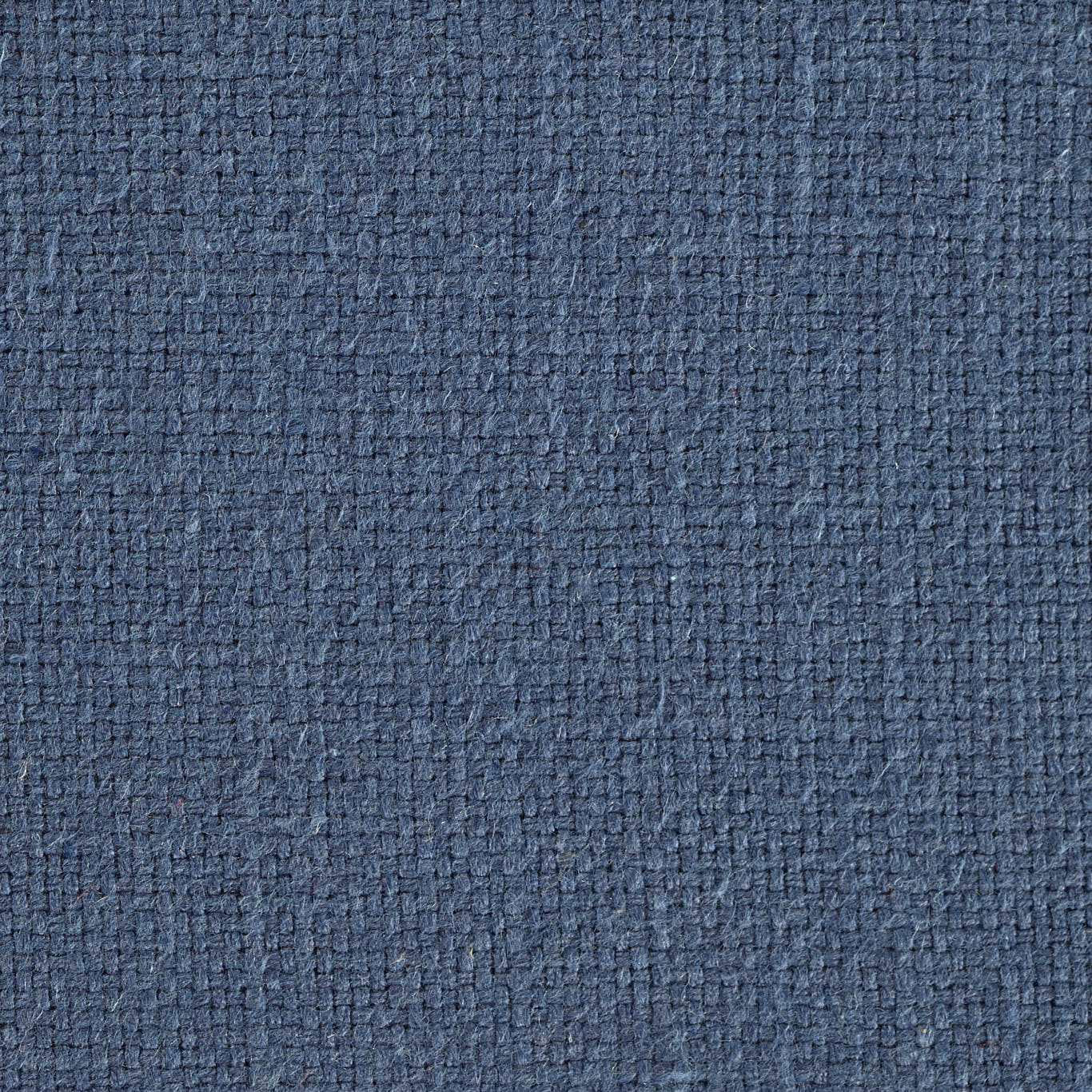Close-up of muted indigo woven fabric with a tight textured surface