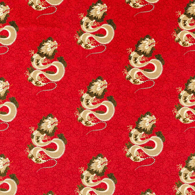 Red dragon-patterned fabric with cream and olive motifs on a dense woven ground