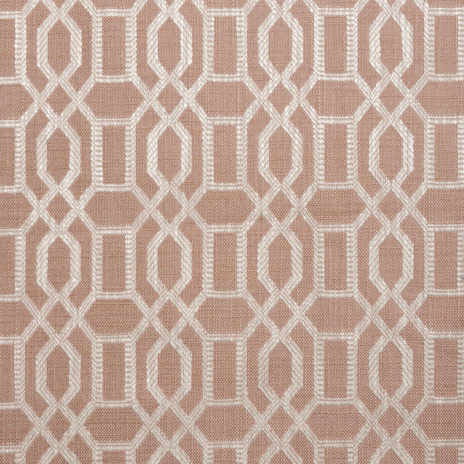 Dusty blush pink woven fabric with an ivory interlocking geometric trellis pattern