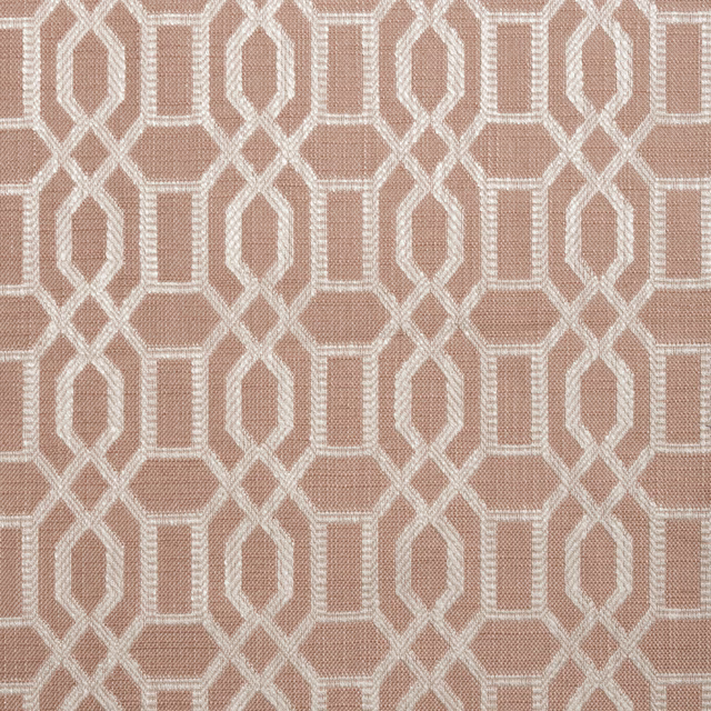 Dusty blush pink woven fabric with an ivory interlocking geometric trellis pattern