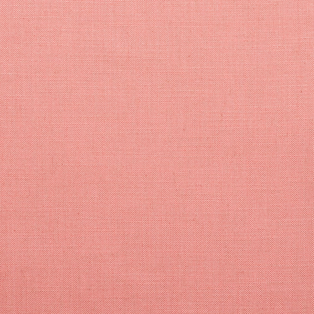 Warm coral-pink finely woven textile with subtle crosshatch texture