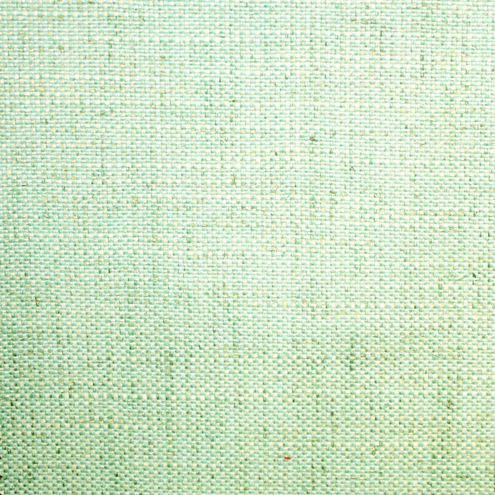 Close-up of pale seafoam green plain weave with mint and white flecks