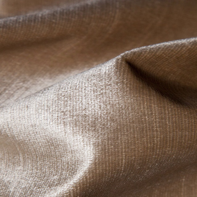 Warm mushroom-taupe plain weave fabric gathered into softly reflective folds