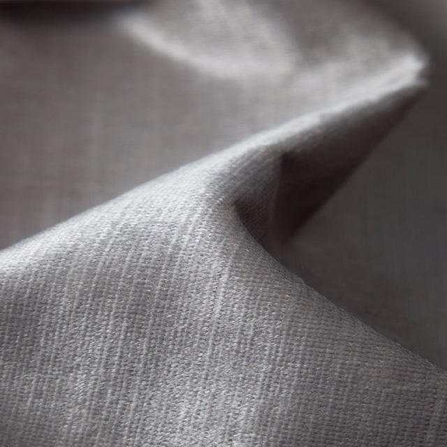 Soft warm-grey plain weave with fine vertical texture, folded in close-up light