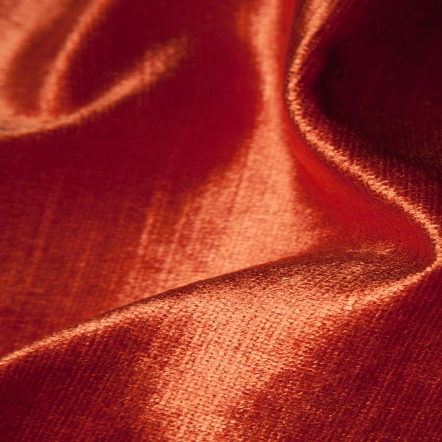Deep garnet-red velvety fabric with copper highlights and dark wine shadows