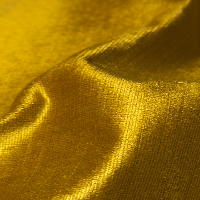 Deep mustard-gold textile with fine woven grain and luminous folded sheen